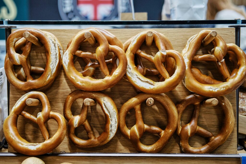 Soft pretzels displayed on hooks.