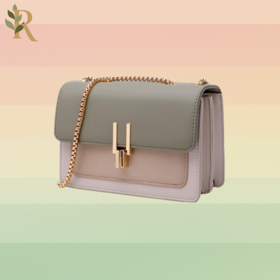 A gray and pink bag with a gold chain