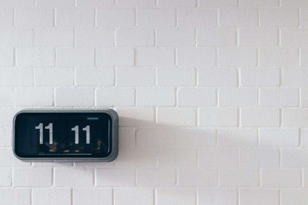 black and gray digital wall clock reading 11:11