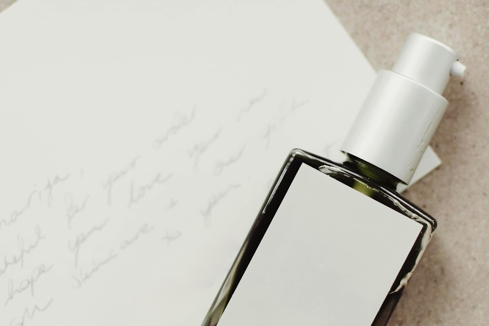 perfume in front of letter