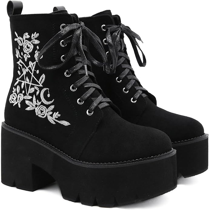 A pair of chunky black ankle boots with floral embroidery and a big star and moon.
