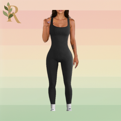 A woman wears a full-body ribbed jumpsuit and white crew socks as her Pilates outfit against the Revivalist branded background.