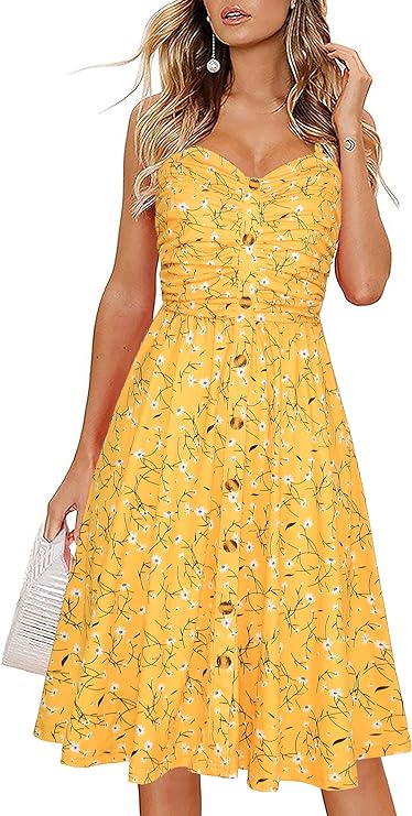 A woman stands in a yellow floral midi sundress with spaghetti straps, a sweetheart neckline and buttons down the front.