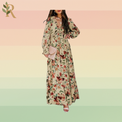 A woman stands in a beige long-sleeve dress with a red and pink floral print. The sleeves end in ruffles in addition to the V-shaped neckline.