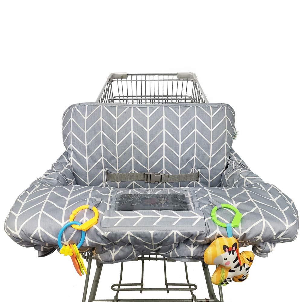 A gray baby grocery cart seat cover sits on a grocery cart. It holds attached toys to entertain the baby that will eventually sit within it.