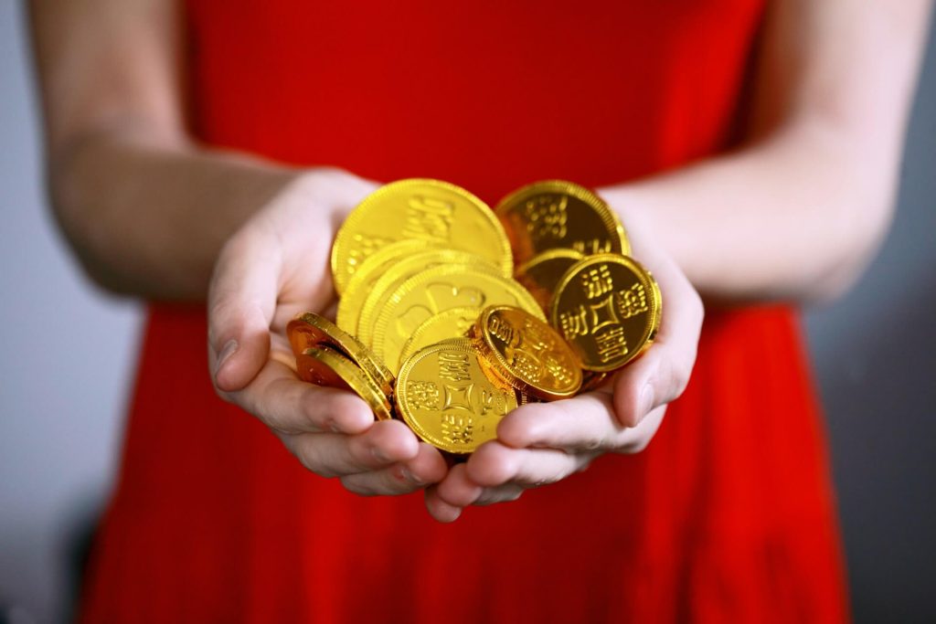 Person holding golden coins