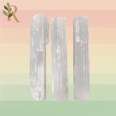 Three white Selenite charging crystals stand against the Revivalist branded background.