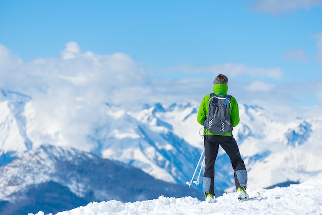 Woman hiking on snowy mountain.