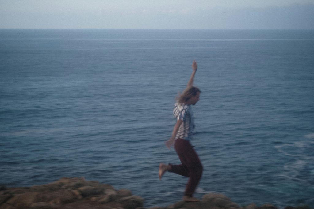 person running in the ocean