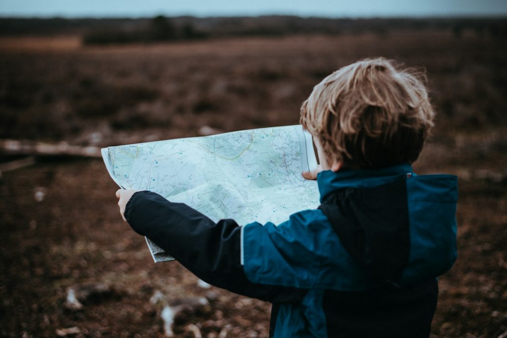 A child holding a map.