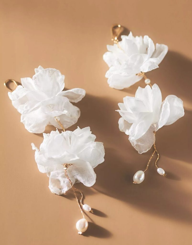 Earrings with large white flowers and pearls.