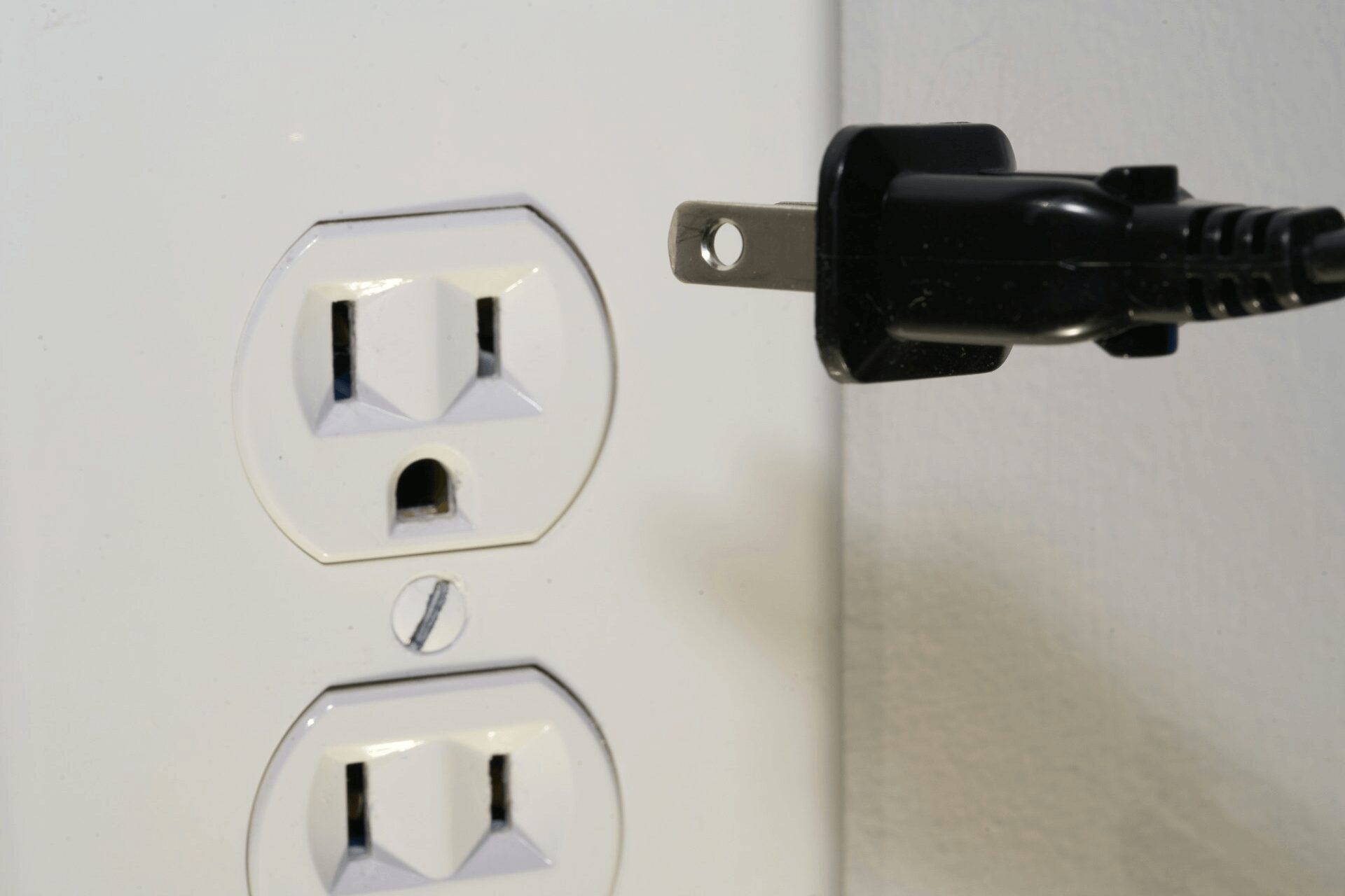 keep your home safe - unplugging a chord from the power outlet