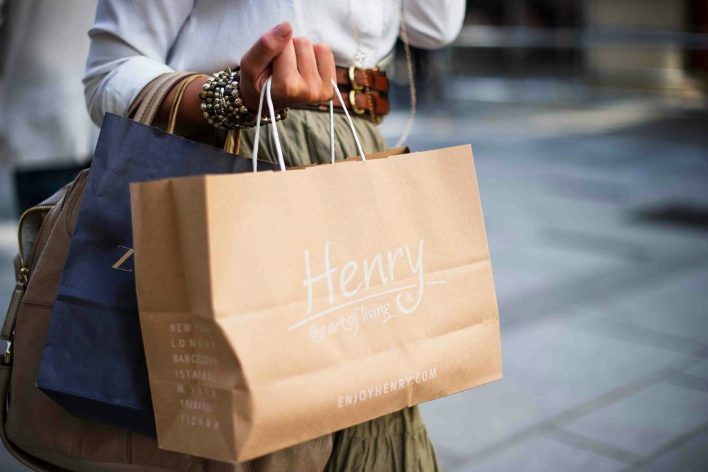 A woman holding shopping bags.