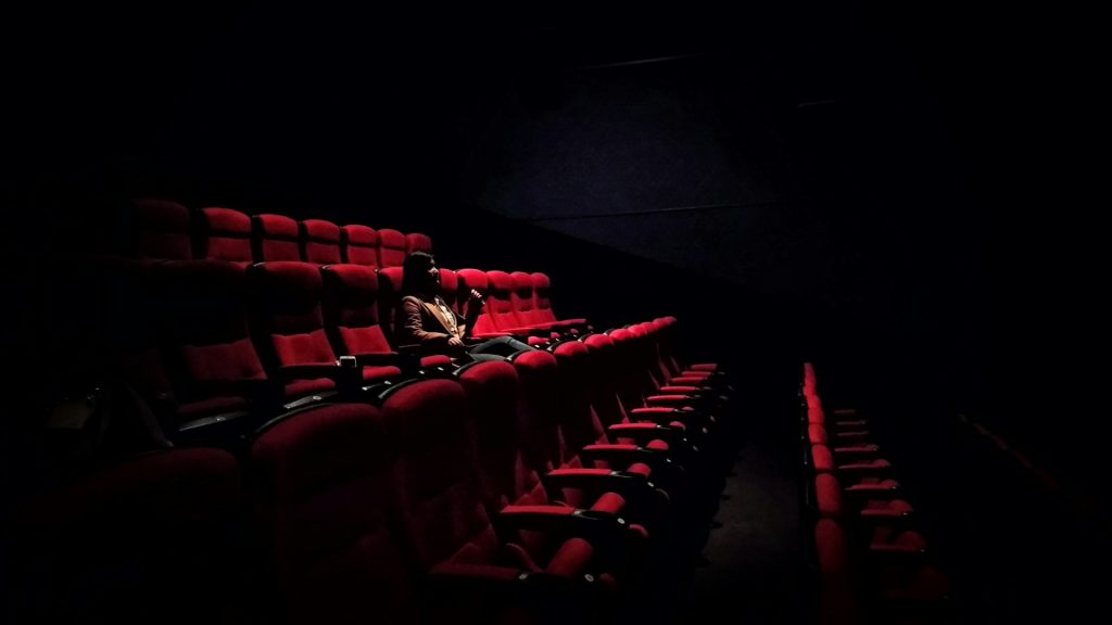 A woman sitting in a movie theater.