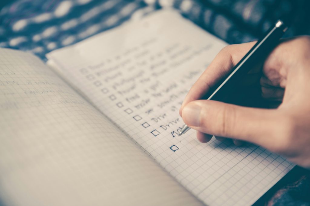 A person writing a to do list.