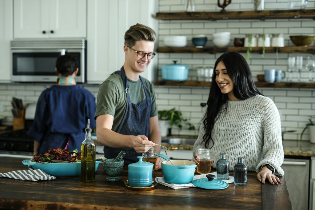 Smiling man and woman cooking together