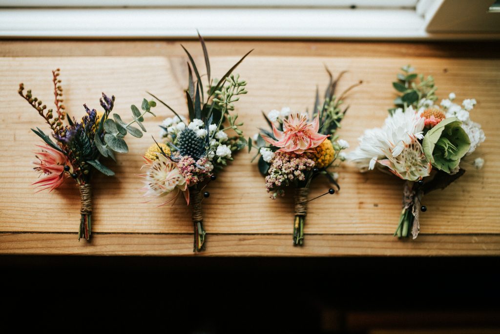 Four wedding boutonnieres.