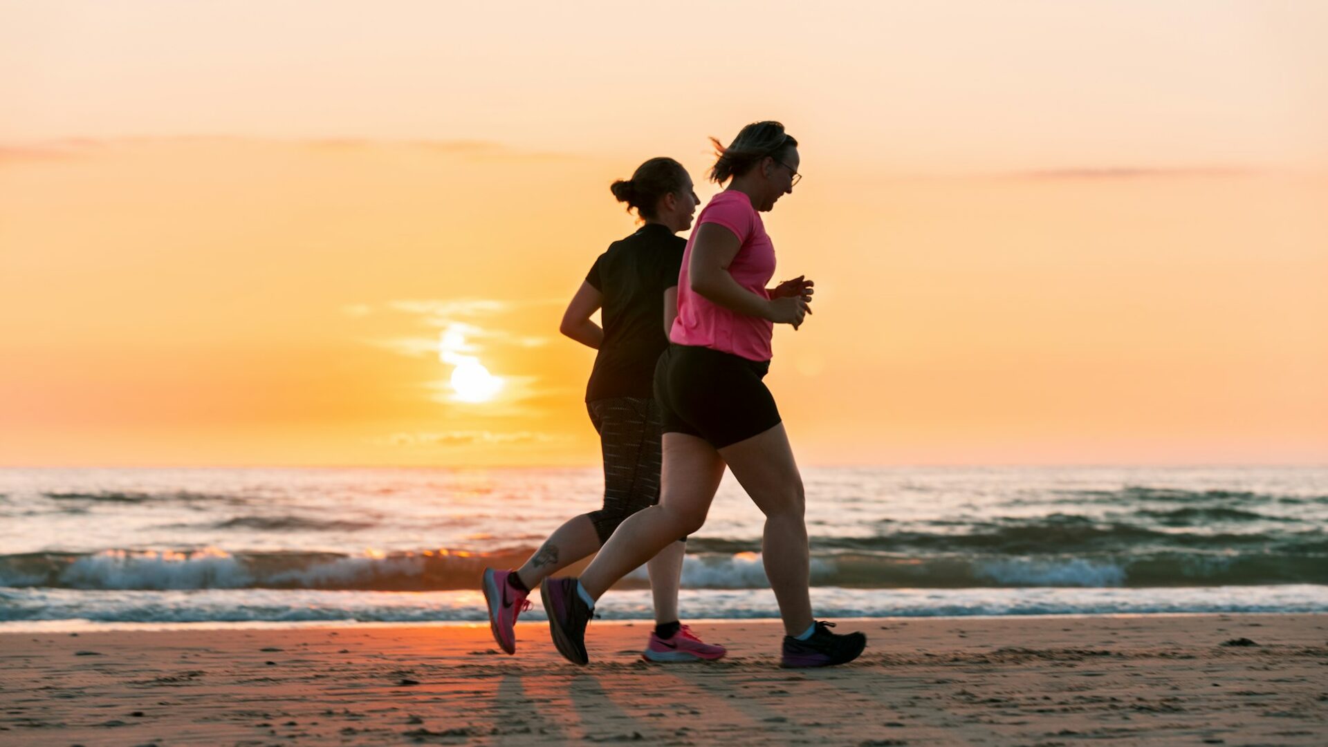 couple running by the beach