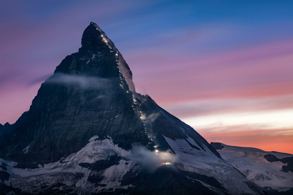 A snow-capped mountain at sunrise.