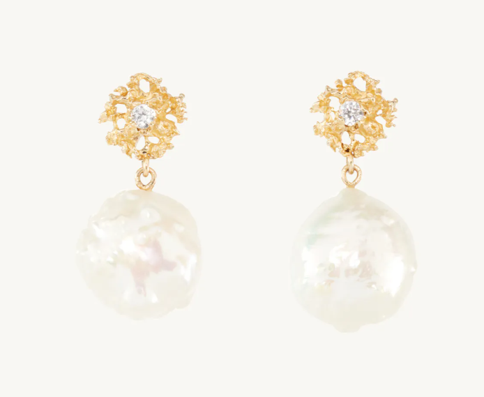 Earrings with gold starbursts and drop pearls.