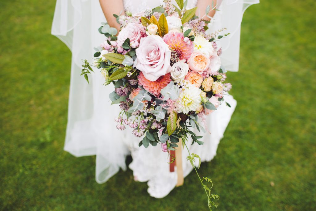 A bride holds a wedding bouquet.