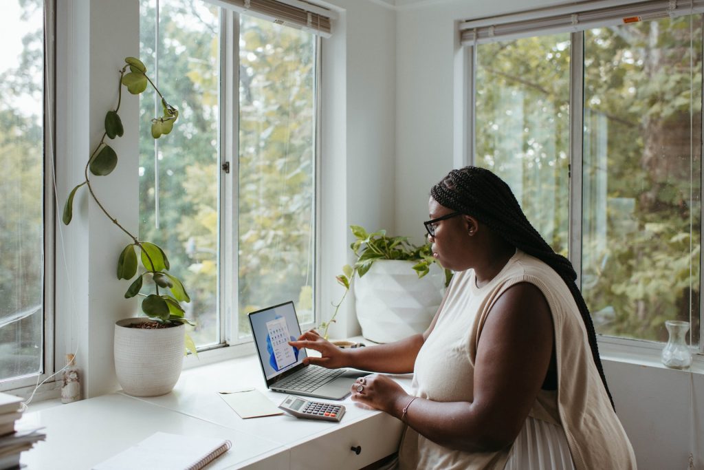 A woman works on a laptop.