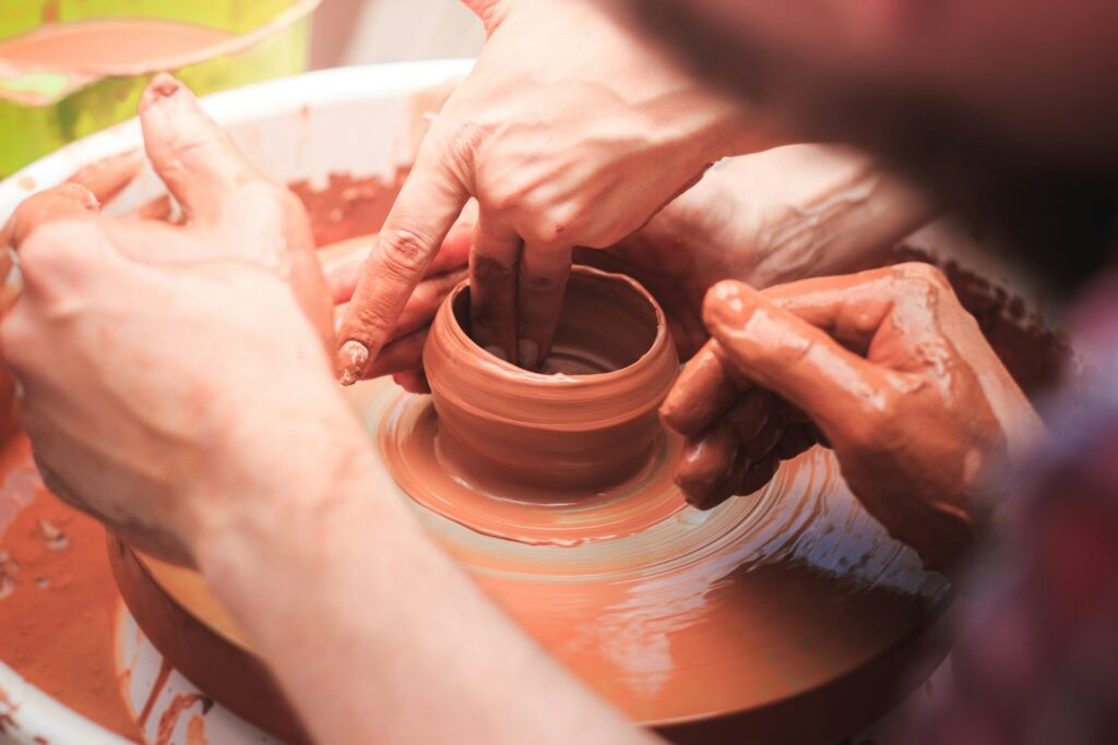 two hands making clay together for a valentine’s date ideas