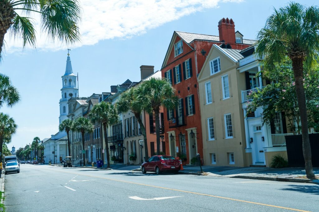 A street of differently colored buildings and palm trees in Charleston, South Carolina