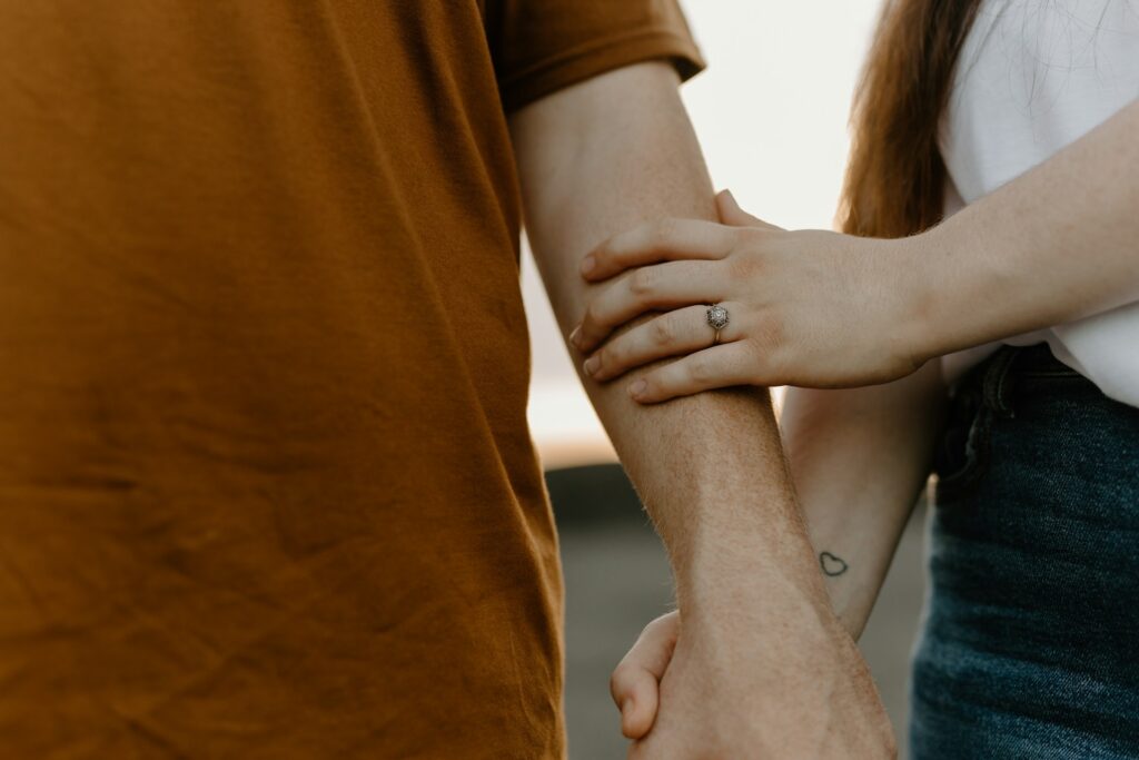 couple holding hands ring tattoo