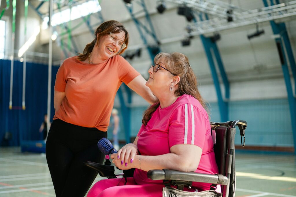 two women talking, one of them is in a wheelchair
