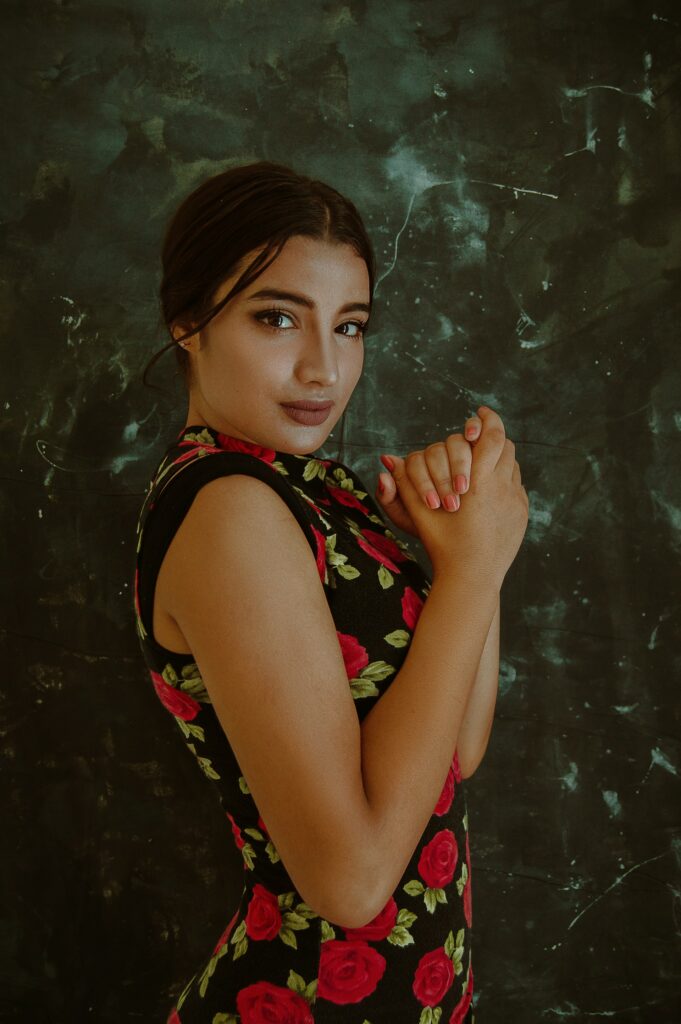 woman in black dress with a red roses pattern