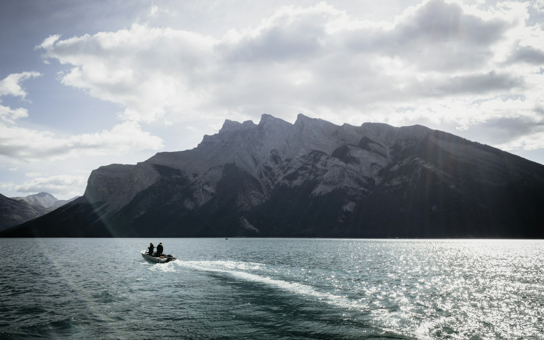 boat on the water in front of a mountain range