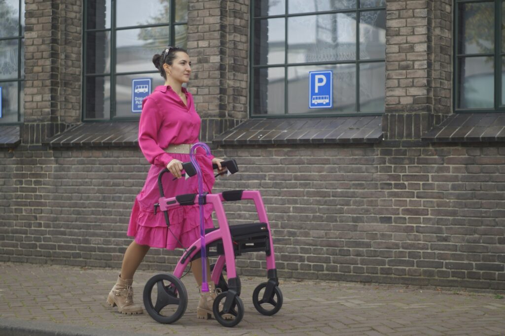 woman in a pink dress with a pink rollator
