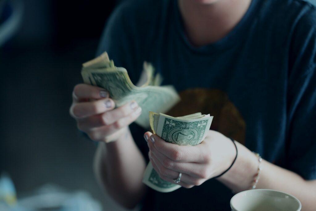 A person counting cash for wedding expenses.