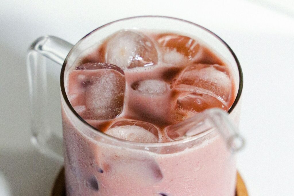 Creamy vanilla cherry nightcap mocktail in a glass with ice