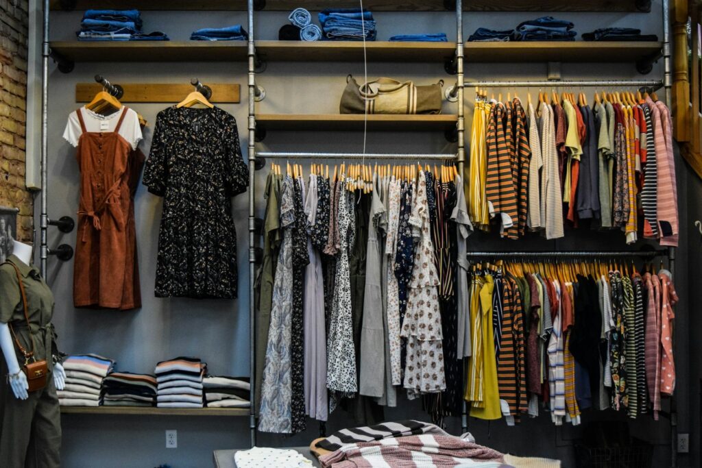 A clothing store interior featuring various garments displayed on racks for customers to browse.