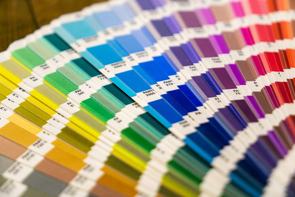 A collection of color swatches arranged on a table, showcasing various hues and shades for design selection.