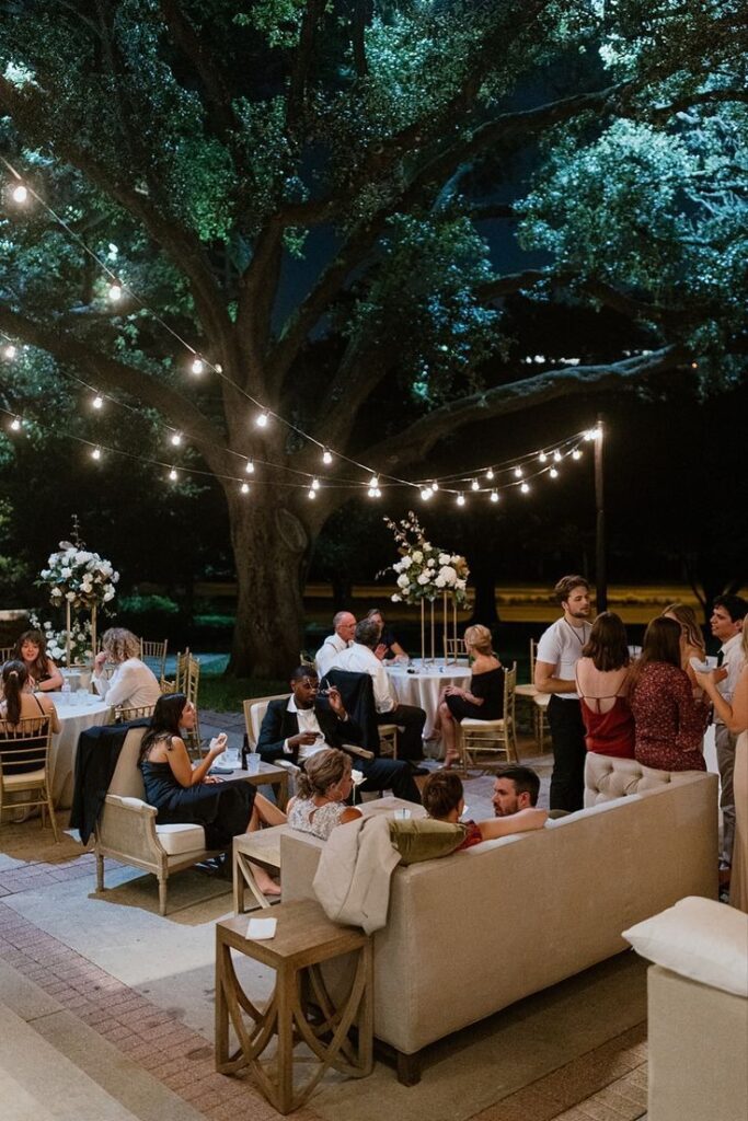 People at outdoor venue on couches, chairs and at tables