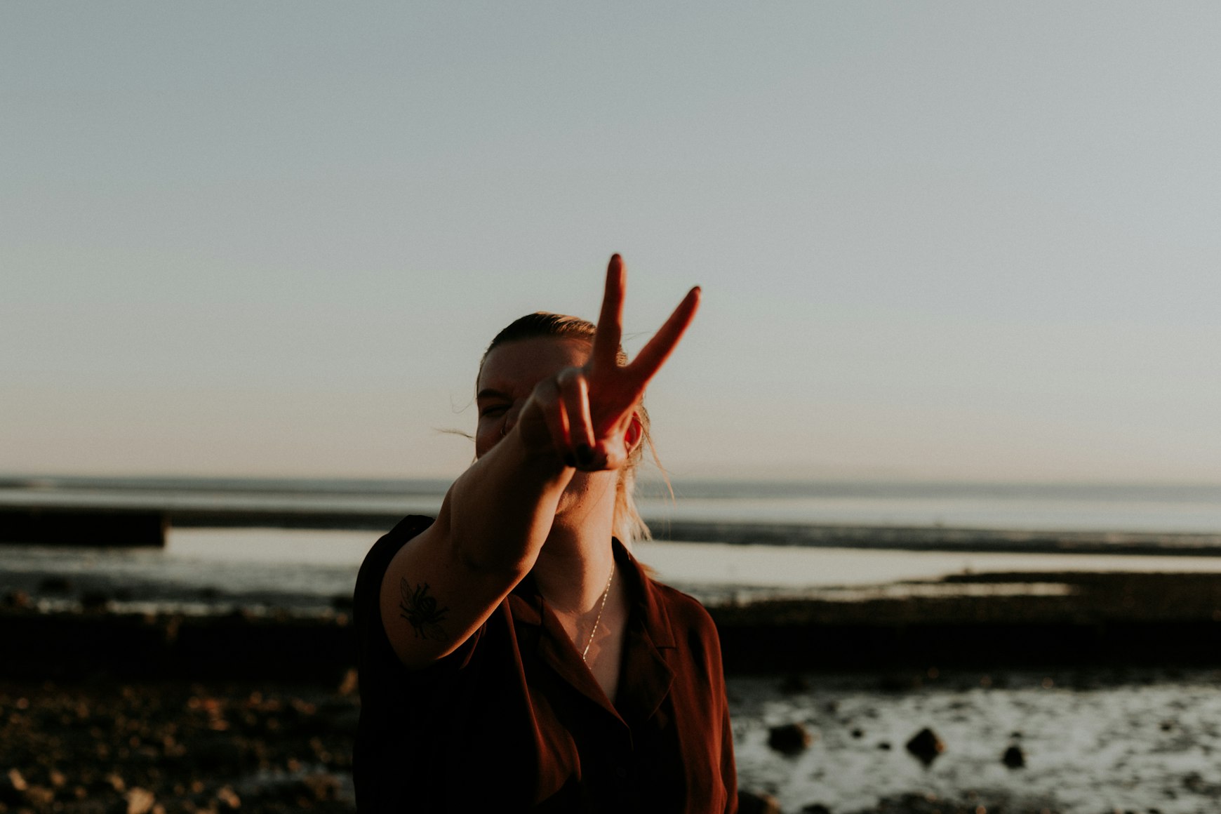 woman making a peace sign