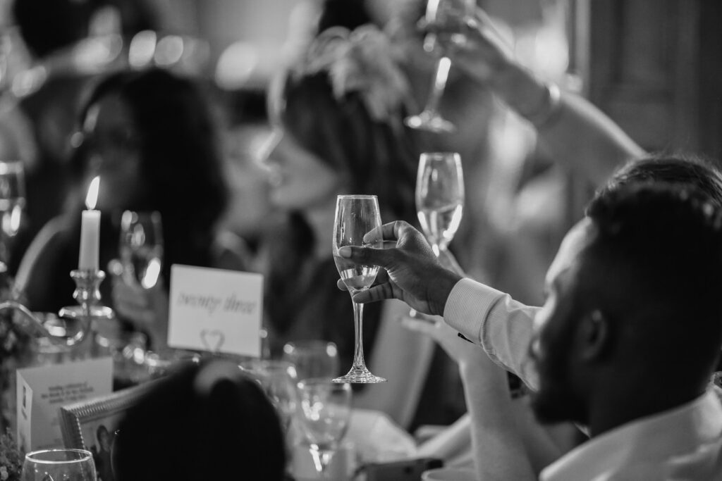 Wedding guests raising their glasses.