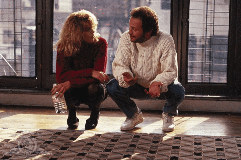 Harry and Sally sitting on the floor together in a scene from When Harry Met Sally