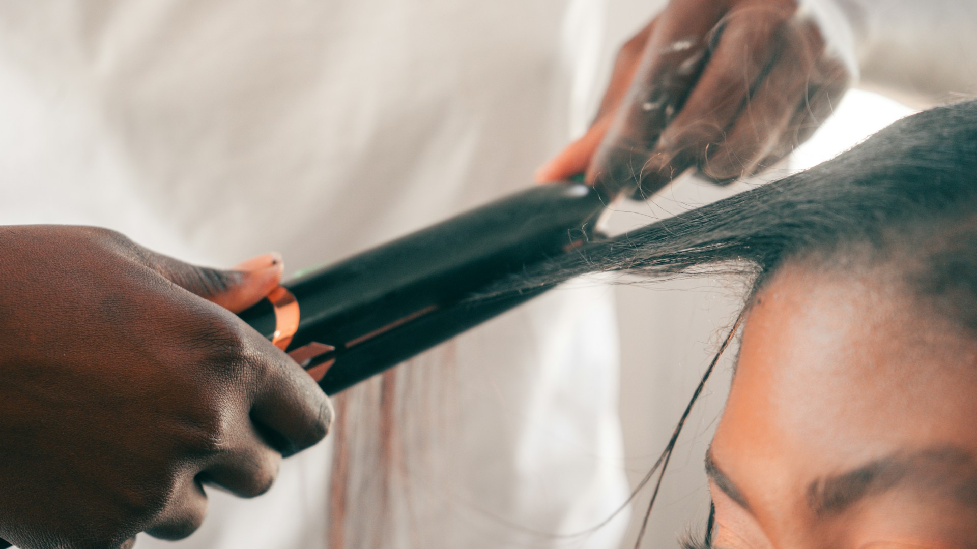 woman getting her getting hair straightened
