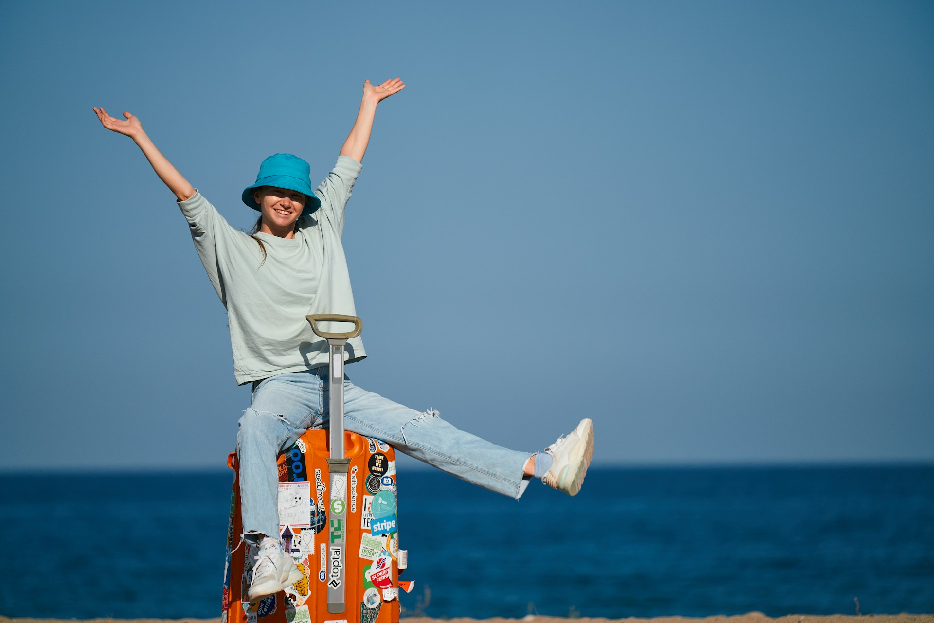 woman sitting on a suitcase in a solo road trip