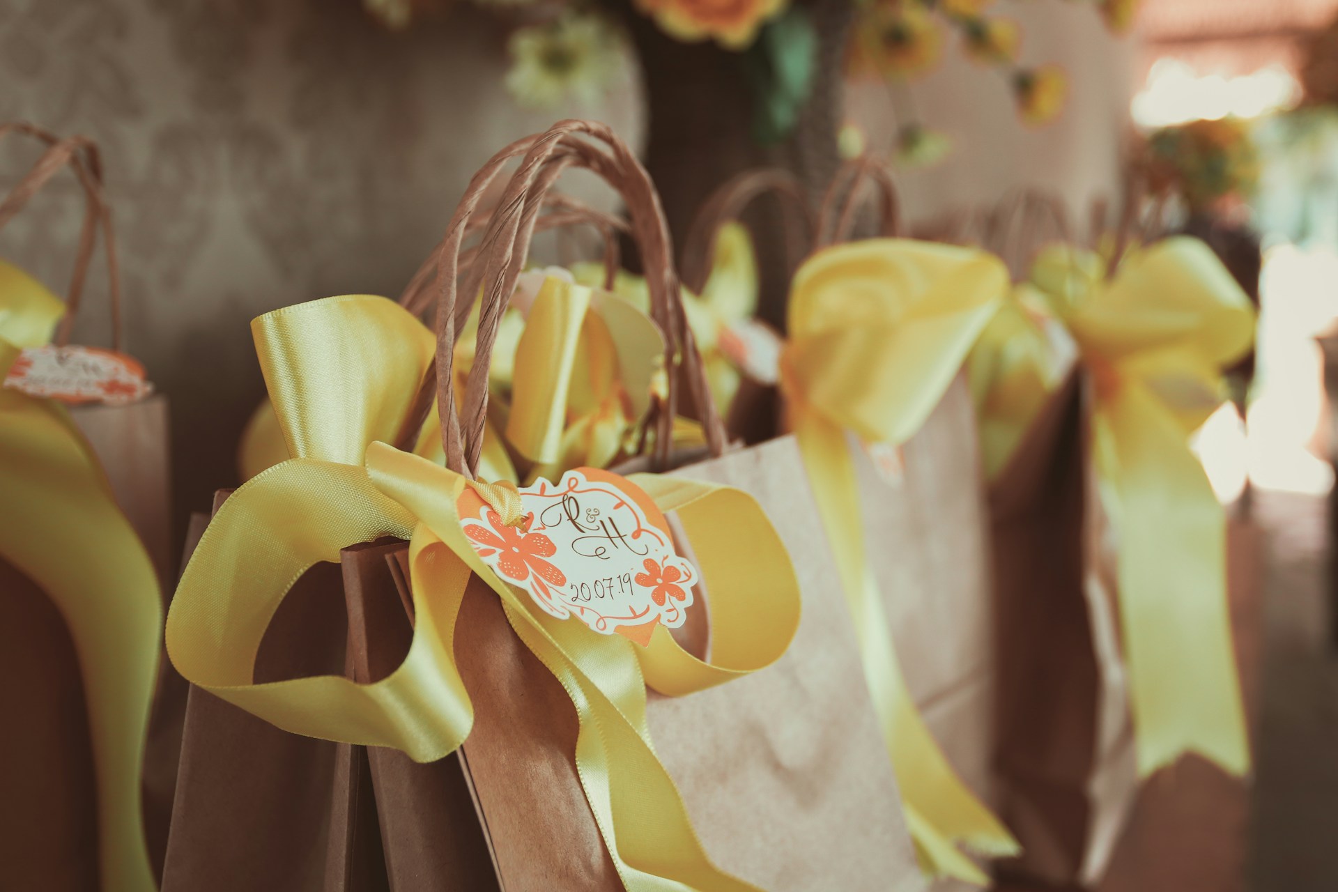 A collection of yellow and orange wedding bags arranged neatly, showcasing their vibrant colors and elegant designs.