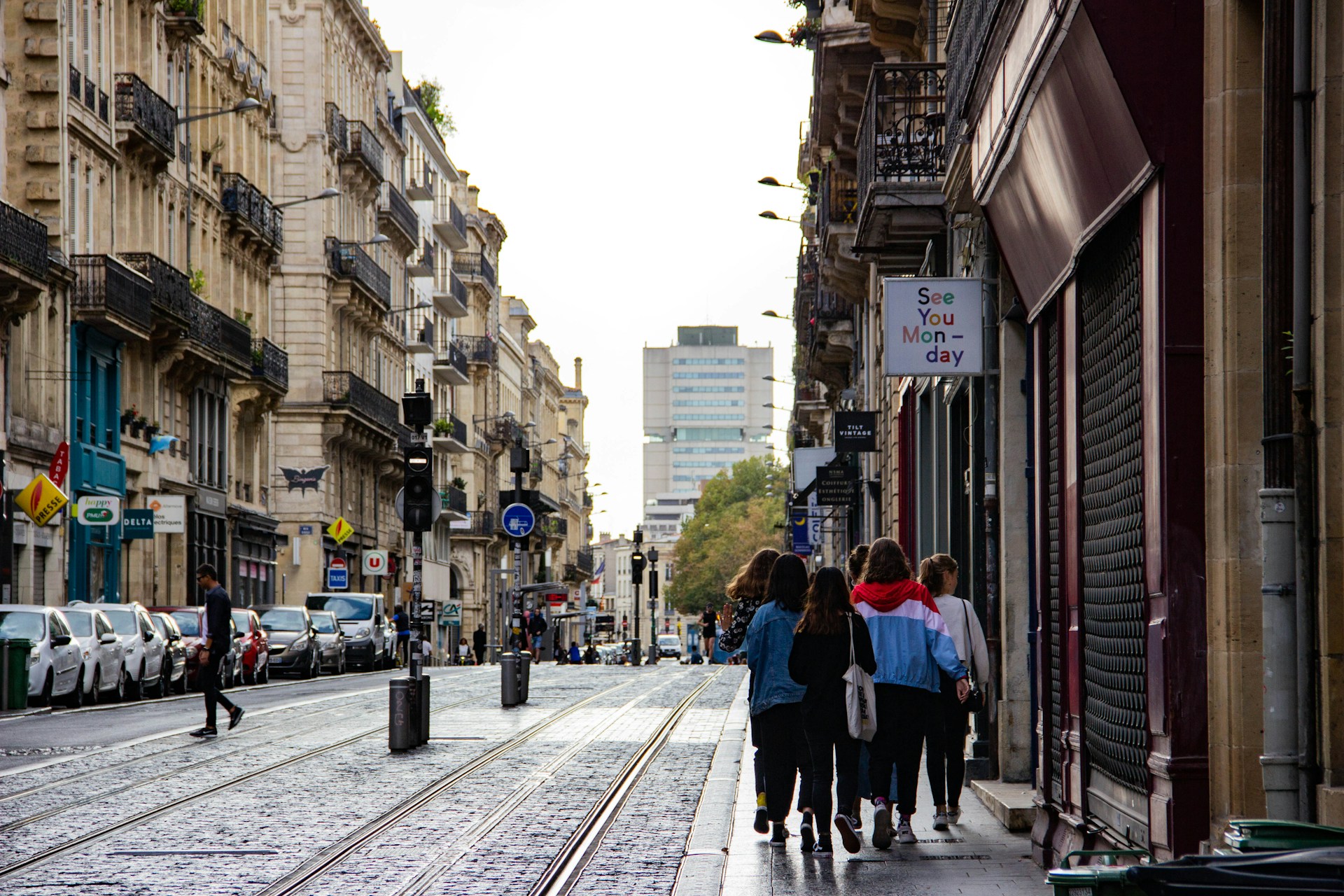 A mixed group of pedestrians walking side by side on a vibrant street, showcasing community interaction and urban life.