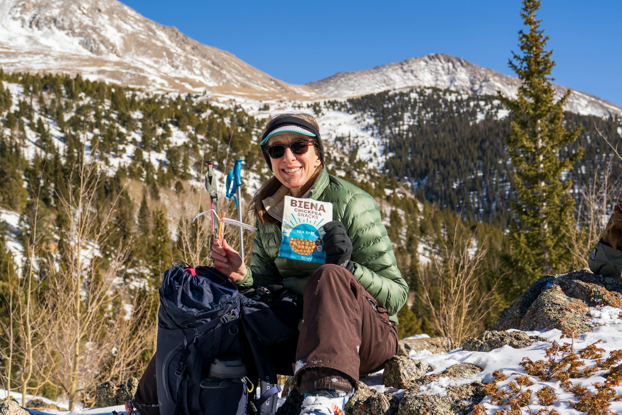 woman eating snacks in the mountains