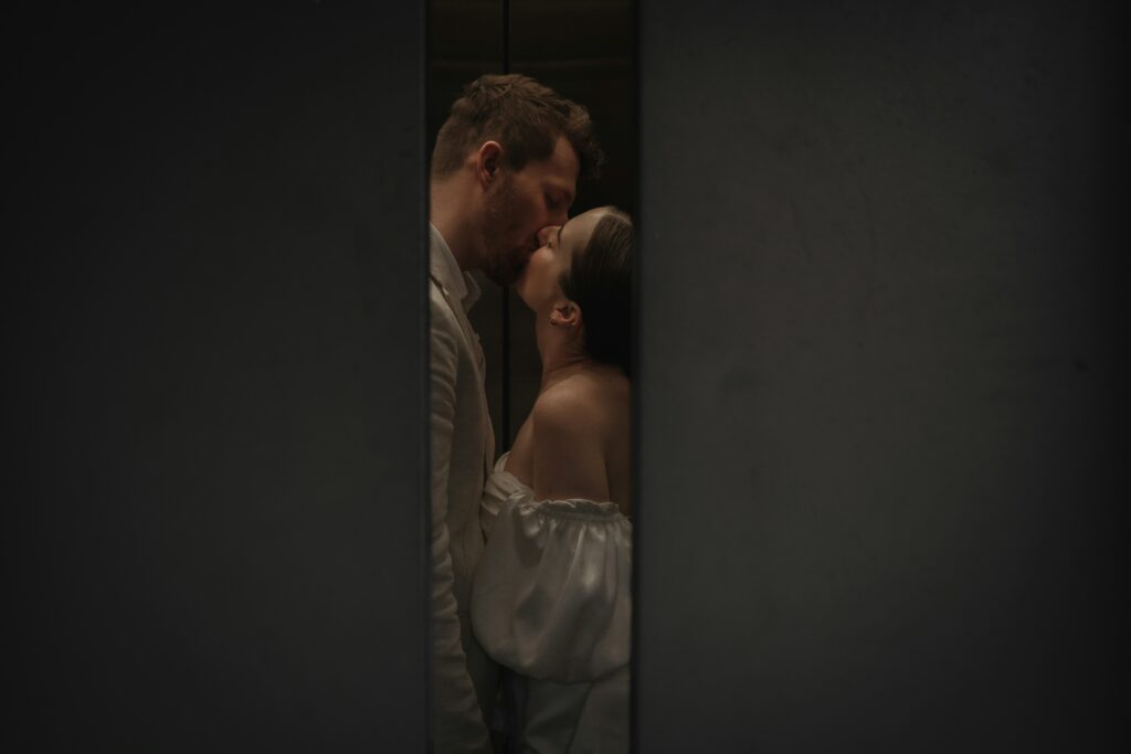 A bride and groom kissing.