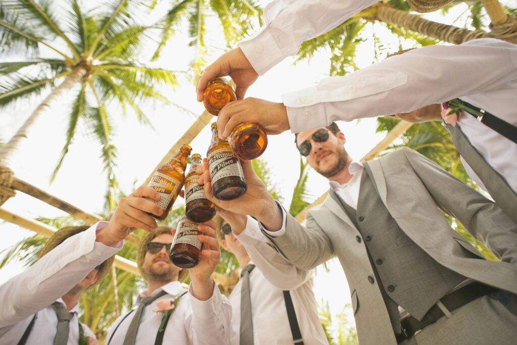 Men doing a cheers with beer bottles