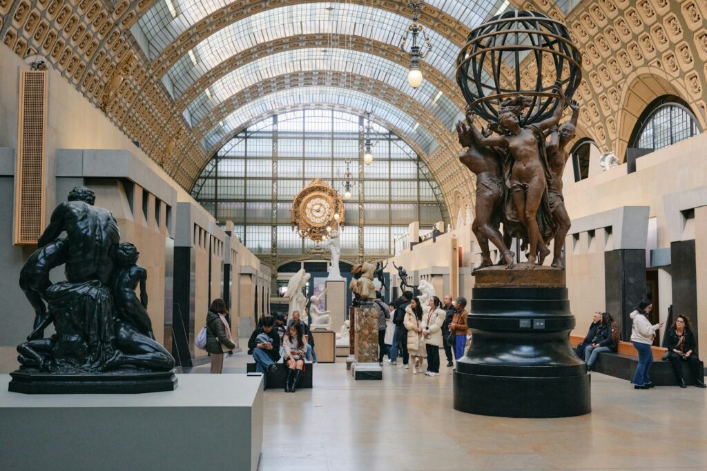 The interior of a museum with arched ceilings and statues
