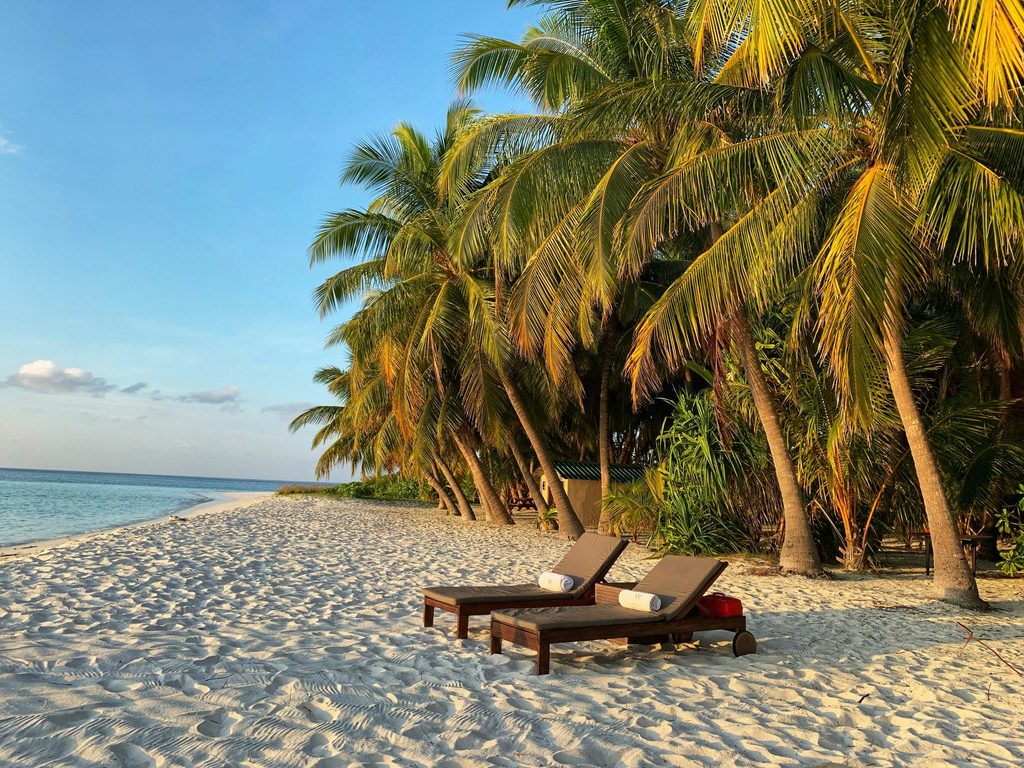 Beach chairs along the shore in the Maldives.